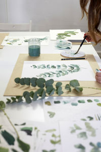 Midsection of woman drawing on map