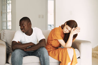 Young couple sitting on sofa