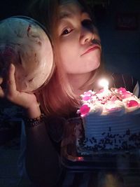 Portrait of girl with hands holding candles