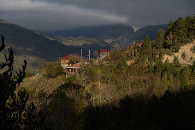 Scenic view of trees and mountains against sky