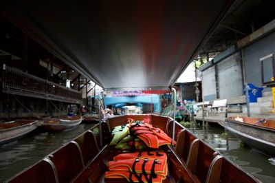 Boats moored in canal in city