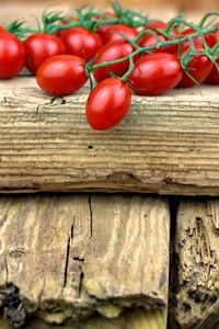 Close-up of tomatoes on wooden plank
