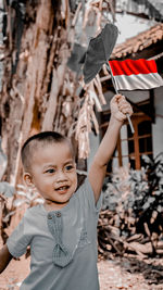 Portrait of smiling boy standing outdoors