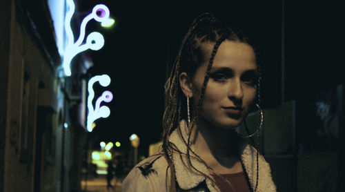 Close-up of young woman at night