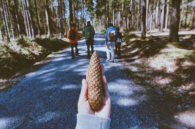 Man holding umbrella in forest