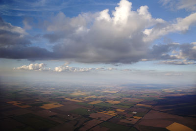 Aerial view of agricultural field against sky