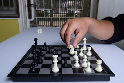 Low angle view of man playing on chess board