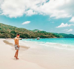 Full length of man standing on beach