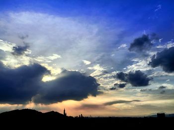 Silhouette trees against sky during sunset