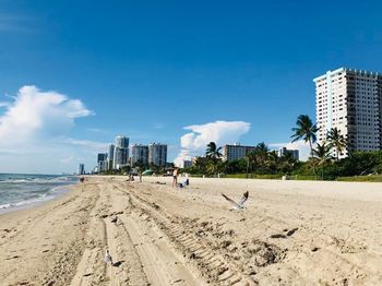 Panoramic view of beach and buildings against sky