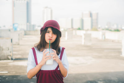 Beautiful young woman standing in city