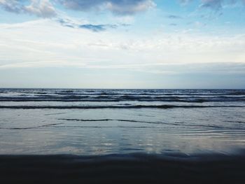 View of calm sea against cloudy sky