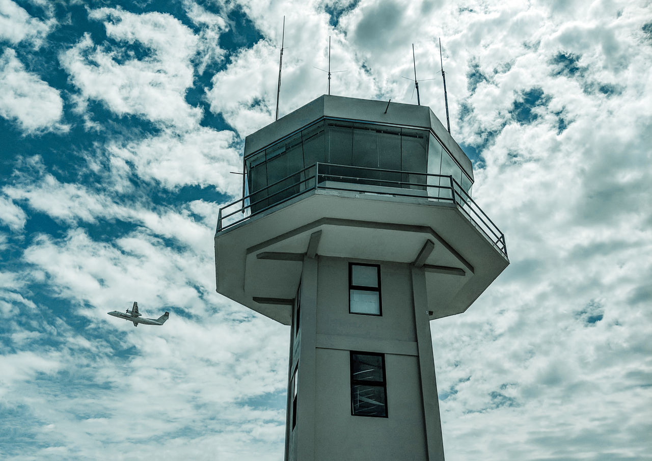 cloud - sky, sky, low angle view, built structure, no people, architecture, building exterior, nature, day, flying, outdoors, security, protection, safety, building, tower, tall - high, bird, cloudscape