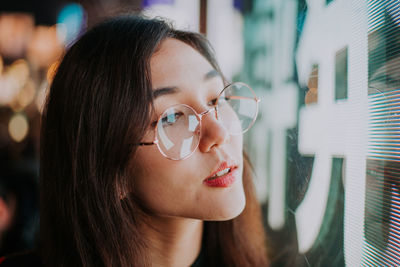 Portrait of a young woman looking away