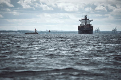 Boat sailing in sea against sky