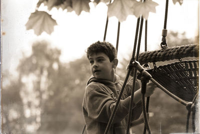 Portrait of boy looking at playground