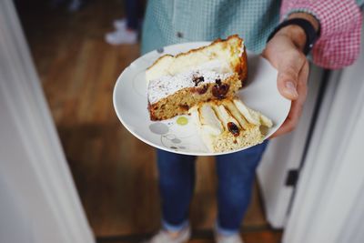 Midsection of woman holding ice cream in plate