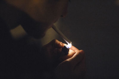 Close-up of man with hands at night