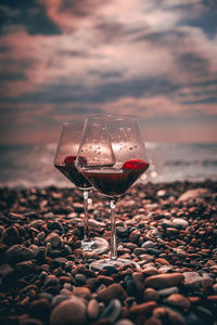 Red wine on rock at beach during sunset
