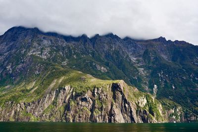 Scenic view of sea and mountains against sky