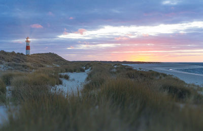 Scenic view of beach against sky during sunset