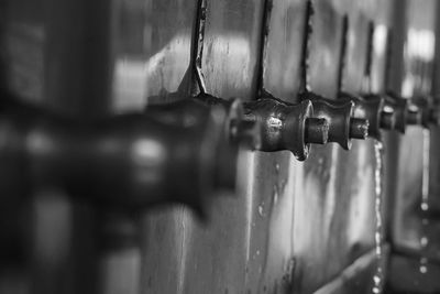 Close-up of faucets in public building