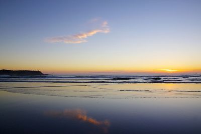 Scenic view of sunset at beach against sky