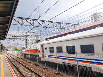 Train at railroad station against sky