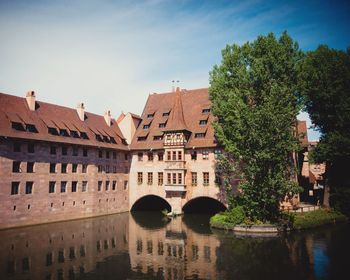 Historic building in canal against sky