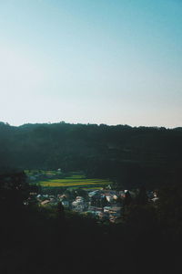High angle view of houses and trees against clear sky