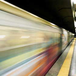 Blurred motion of train at railroad station