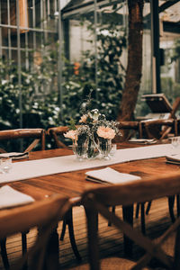 Empty chairs and tables at sidewalk cafe