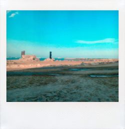 Scenic view of landscape against blue sky