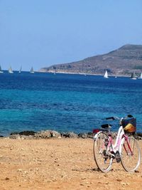 Bicycles on beach against clear sky