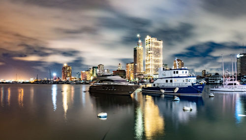 Panoramic view of bay and buildings against sky