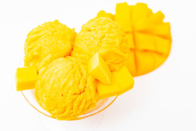 Close-up of yellow cake against white background