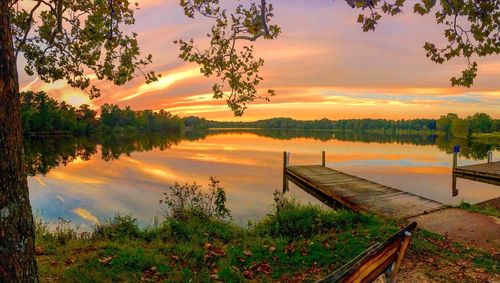 Scenic view of lake against orange sky