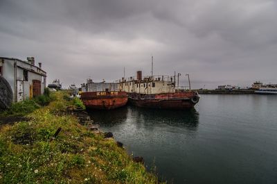 Boats moored on sea against sky