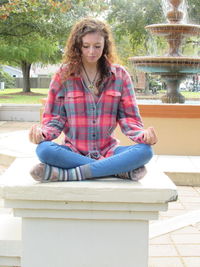 Smiling young woman sitting outdoors