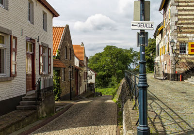 Street amidst buildings against sky