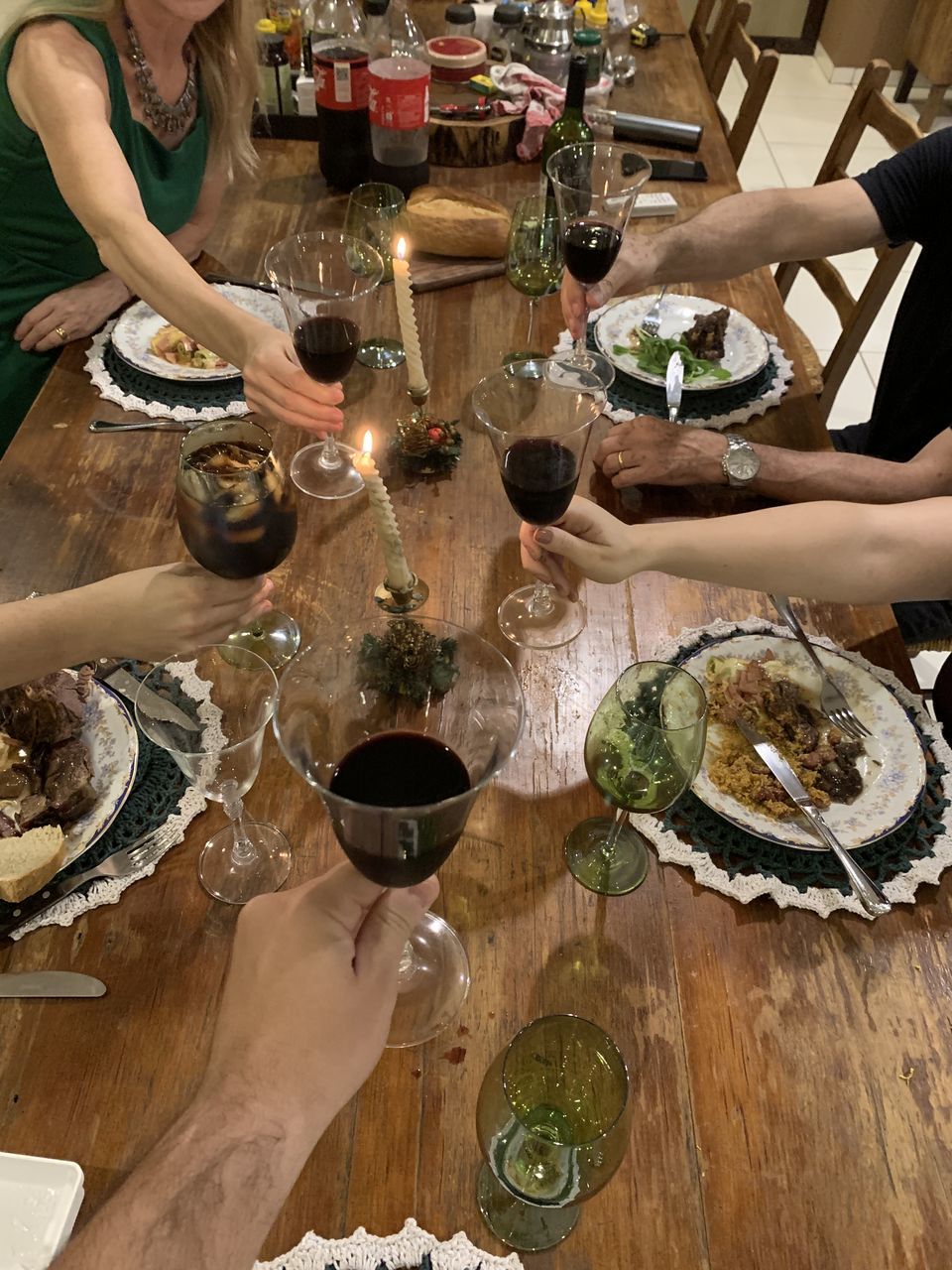 HIGH ANGLE VIEW OF PEOPLE HAVING FOOD ON TABLE