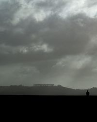 Scenic view of silhouette land against sky