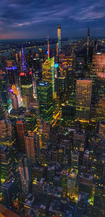 Aerial view of illuminated buildings in city at night