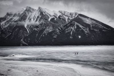 Scenic view of lake against sky during winter