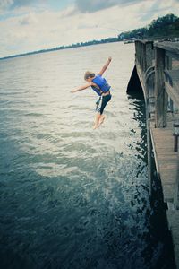 Woman jumping in water