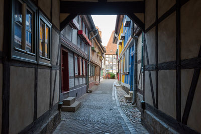 Empty alley amidst buildings