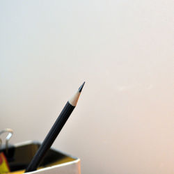 Close-up of pencil against wall