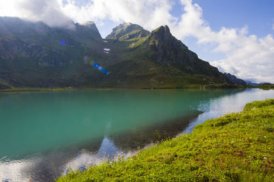 Scenic view of lake and mountains against sky