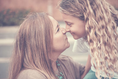 Close-up of mother and daughter rubbing noses