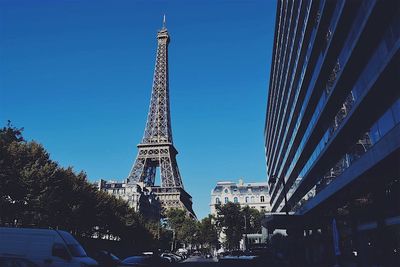 Low angle view of skyscrapers against blue sky